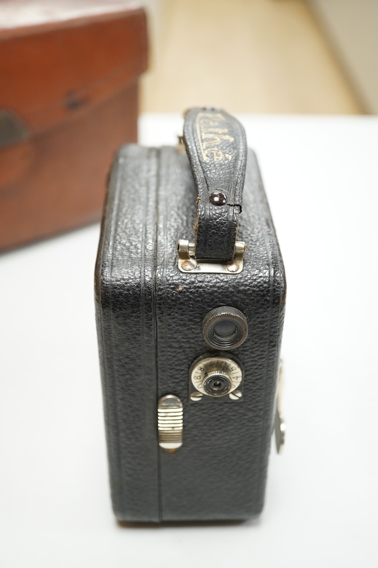 A Pathescope Moto camera 9.5mm cine camera in a brown leather case